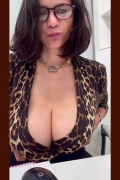 sexy woman with big boobs wearing an open leopard shirt